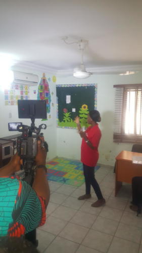 Oluwadamilola Olukitibi (TZF Assistant Training Coordinator) giving a tour of the center to the Nigerian Television Authority (NTA) crew.