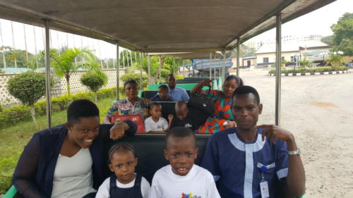 Group photograph of children and staff of The Zeebah Foundation on a train during an excursion to BMT African Gardens