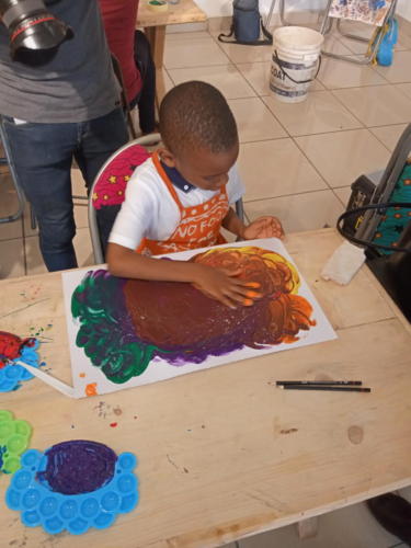 The children having fun while creating gouache abstract art.