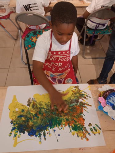 The children having fun while creating gouache abstract art.